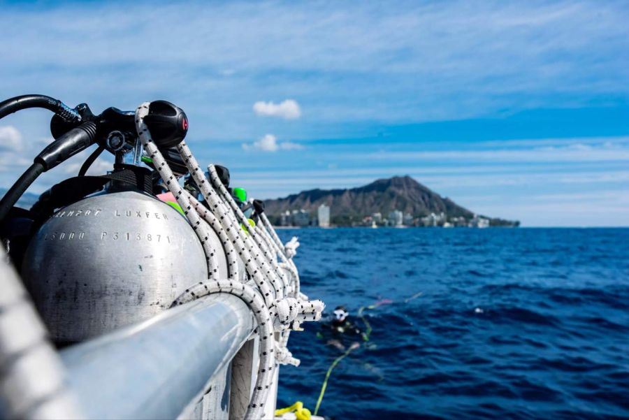 Scuba diving tanks on the Aloha Scuba Diving Company boat with Waikiki and Diamond Head in the background.